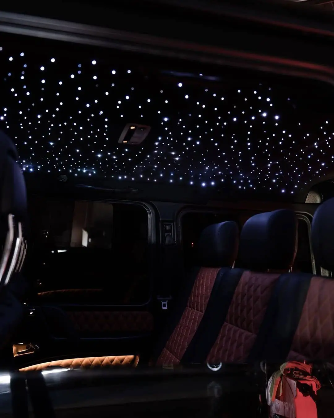 Wraptors Orlando, Vehicle Wraps, PPF & Tint Interior of a luxury vehicle with quilted seats and a ceiling featuring star-like LED lights, expertly protected with premium PPF by Wraptors Orlando—your top choice for Orlando Florida Car Wraps. Orlando, FL